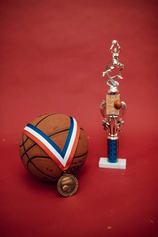 a basketball trophy and a basketball ball on a red surface, by Greg Spalenka, dribble contest winner, decorated, winning awards, tall, artsation contest winner