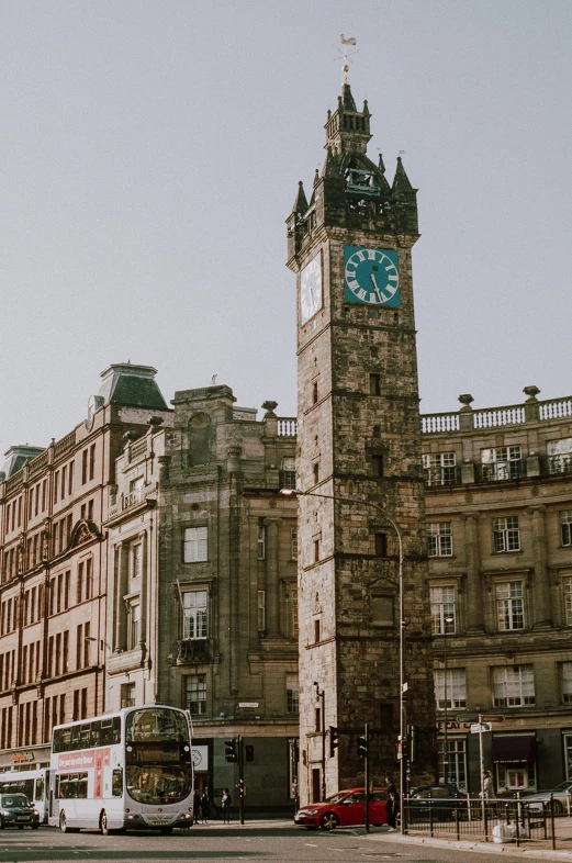 a tall clock tower sitting in the middle of a city, by John Nicolson, pexels contest winner, art nouveau, scottish style, exterior photo, square, blair armitage