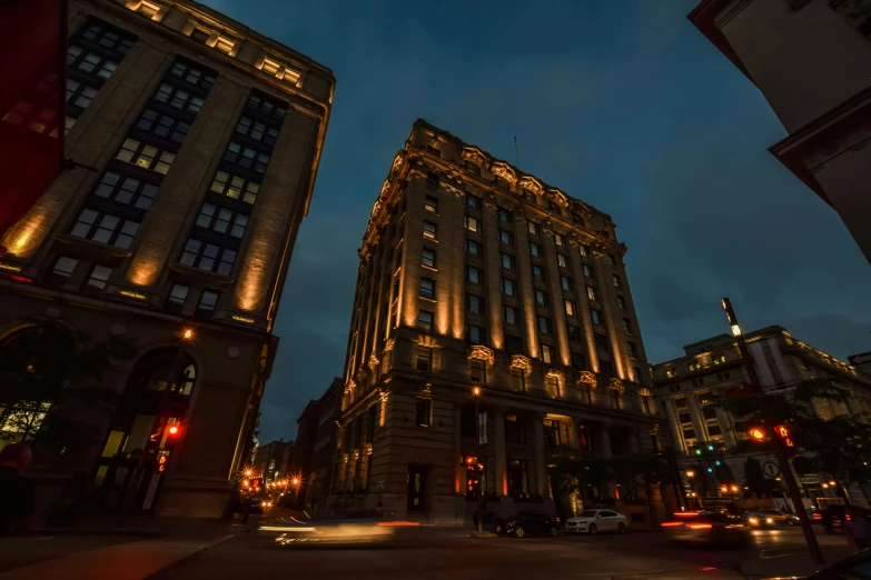 a very tall building sitting in the middle of a city, by Greg Rutkowski, pexels contest winner, art nouveau, front lighting, mcgill, accent lighting : : peugot onyx, ground level shot