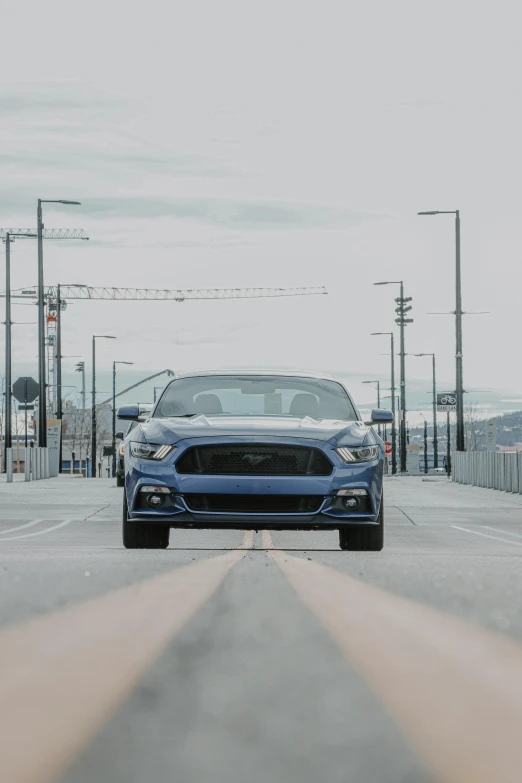 a blue ford mustang driving down a road, by Drew Tucker, unsplash, ultrawide lens”, in front of a garage, avatar image, convertible