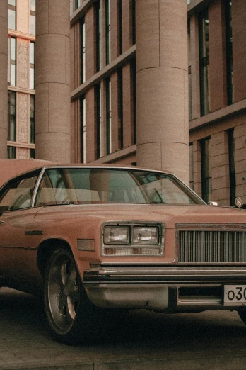 an old car is parked in front of a building, by Attila Meszlenyi, pexels contest winner, photorealism, 1 9 8 0 s movie still, brown and pink color scheme, gold, brown