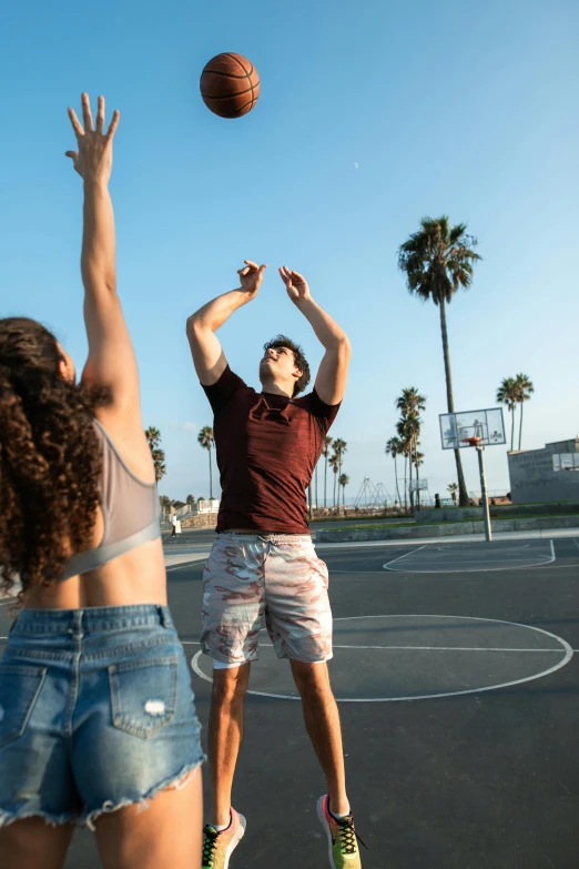 a couple of people playing a game of basketball, wearing denim short shorts, arms spread wide, highly upvoted, los angelos