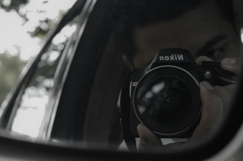 a man taking a picture of himself in a rear view mirror, a picture, by Niklaus Manuel, pexels contest winner, nikon camera 8 k, hiding, with nikon cameras, movie footage