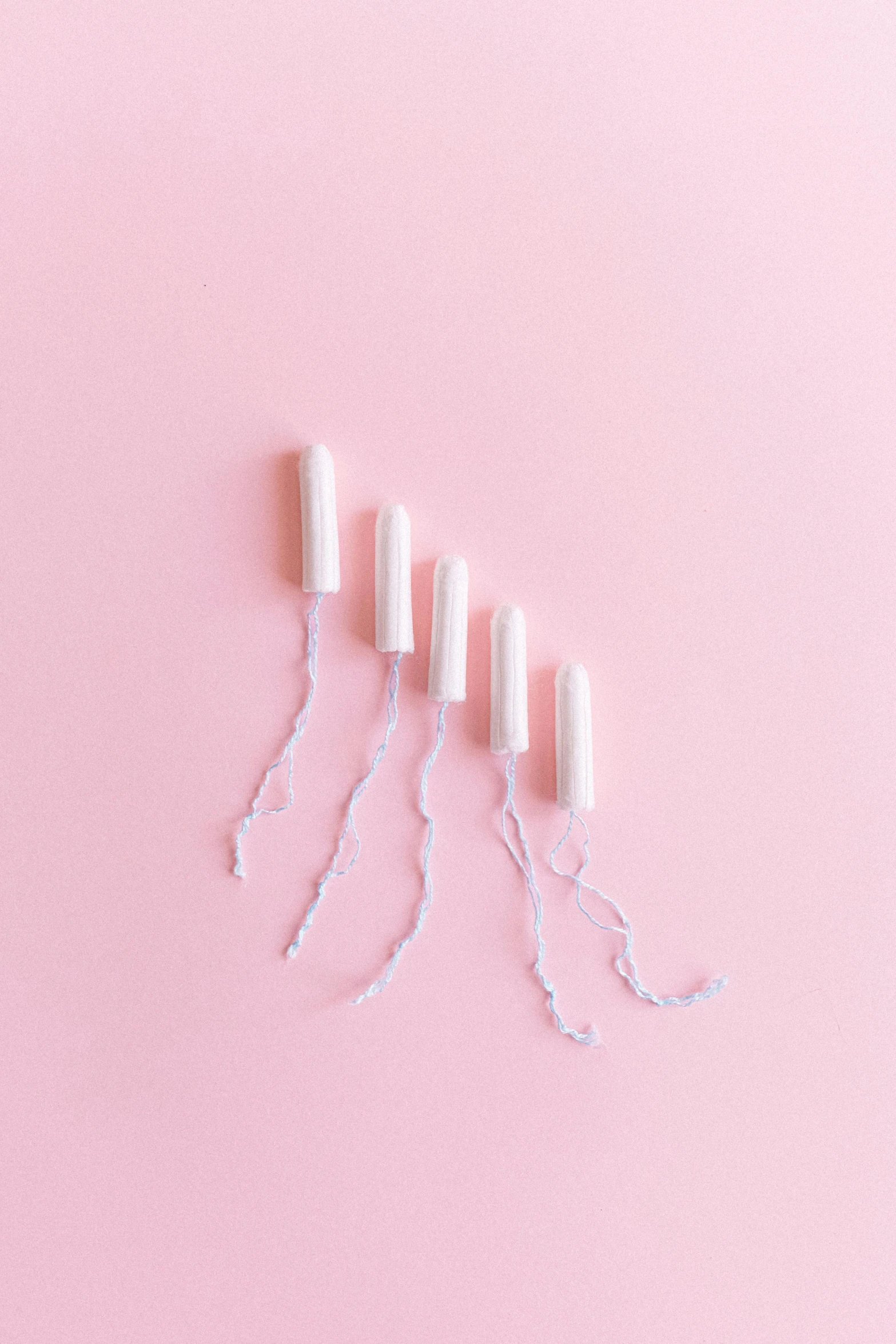 a row of toothbrushes sitting on top of a pink surface, by Elsa Bleda, conceptual art, glowing threads of drop, pregnancy, ilustration, white lightning