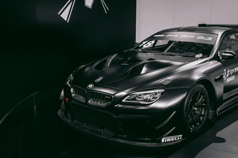 a black sports car on display in a showroom, pexels contest winner, hyperrealism, japanese drift car, bmw, frontal, race style