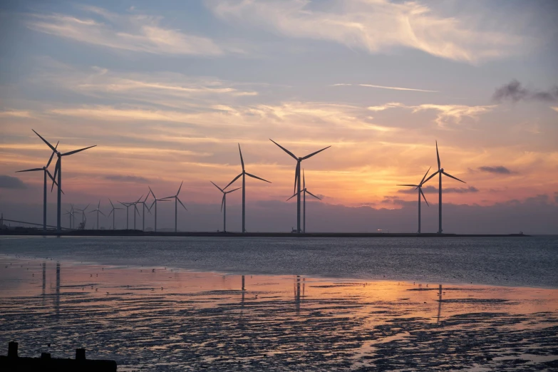 a group of wind turbines sitting on top of a beach, by Jan Tengnagel, pexels contest winner, sunset panorama, slide show, full frame image, thumbnail