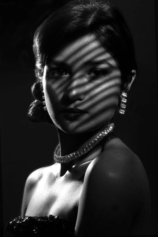 a black and white photo of a woman, inspired by Jerry Schatzberg, jewelry lighting, 1950s korean film noir, gemma chan, striped