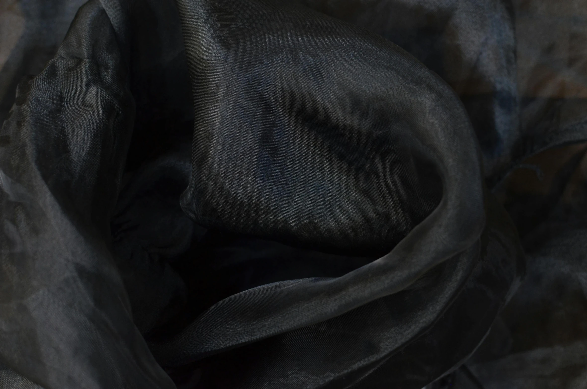 a close up of a black cloth on a table, inspired by Anna Füssli, deviantart, translucent, silk colors, detailed product image, black scarf