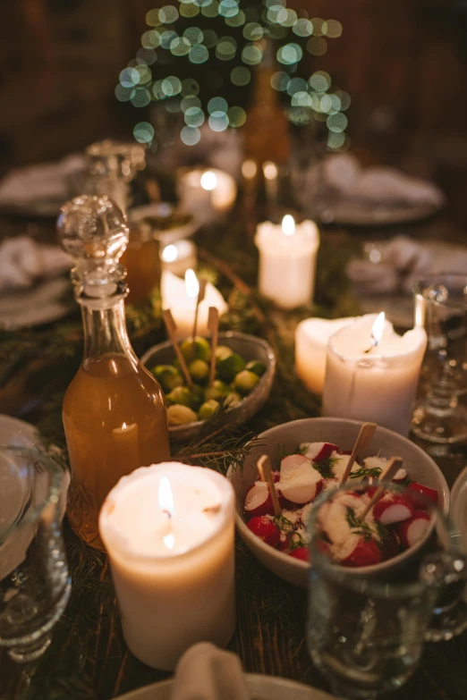 a table topped with plates of food and candles, profile image, soft light, gardening, drink