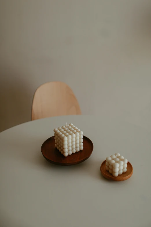 a close up of a plate of food on a table, a marble sculpture, inspired by Isamu Noguchi, kinetic art, milk cubes, voxel, pearls, ignant