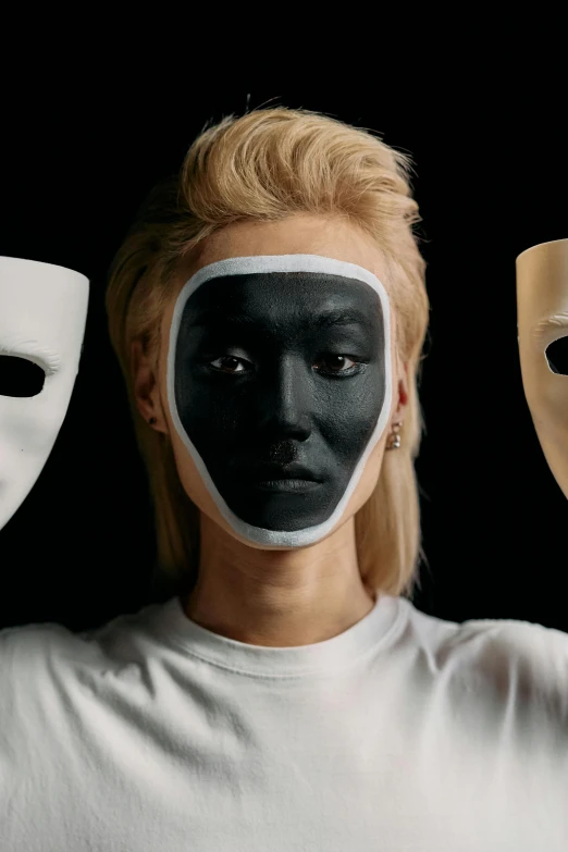 a woman holding three masks in front of her face, a black and white photo, antipodeans, all from the group nct, rankin, vantablack, with a white complexion