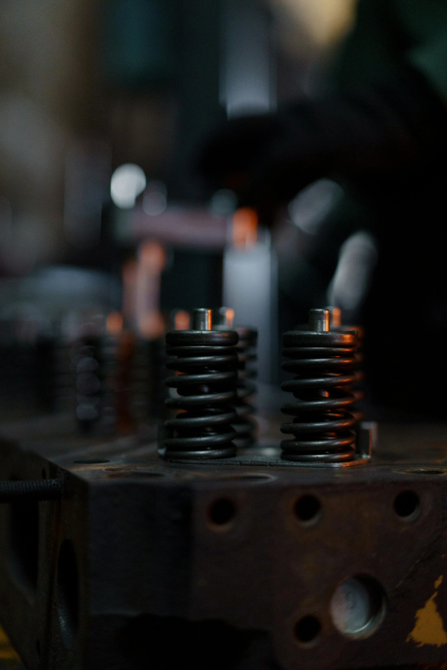 a close up of a metal object on a table, by Adam Marczyński, unsplash, heated coils, tall metal towers, the blacksmith, pistons