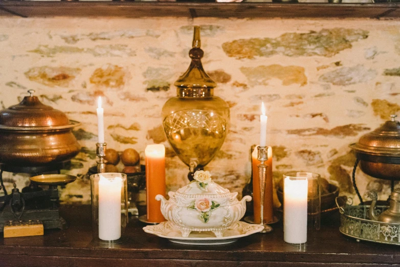 a group of candles sitting on top of a table, ivory carved mantle, tea drinking and paper lanterns, amber glow, profile image