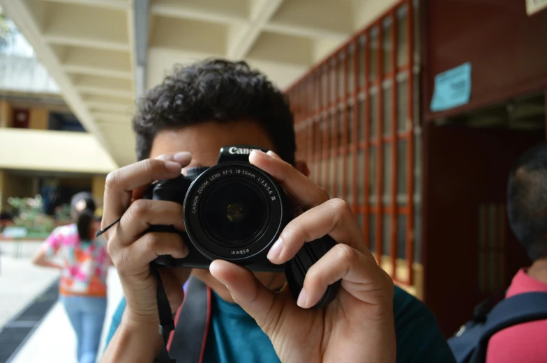 a man taking a picture with a camera, student, photo taken in 2018, photography]