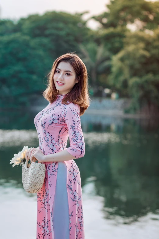 a woman standing next to a body of water, a picture, inspired by Cui Bai, happening, ao dai, avatar image, girl cute-fine-face, square