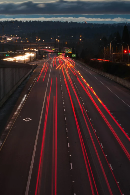 a highway filled with lots of traffic under a cloudy sky, an album cover, unsplash, renaissance, red led lights, thumbnail, running lights, seattle