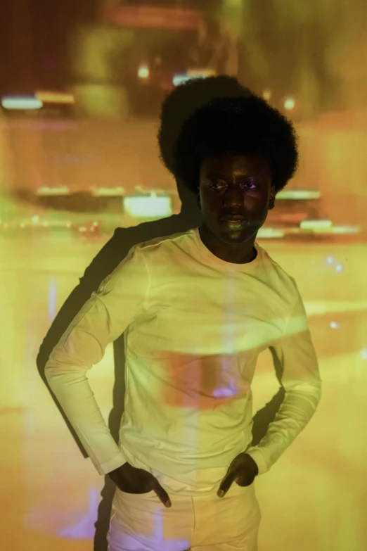 a man standing with his hands on his hips, an album cover, by Winona Nelson, pexels contest winner, afrofuturism, white glowing aura, black man with afro hair, glowing with colored light, in white turtleneck shirt