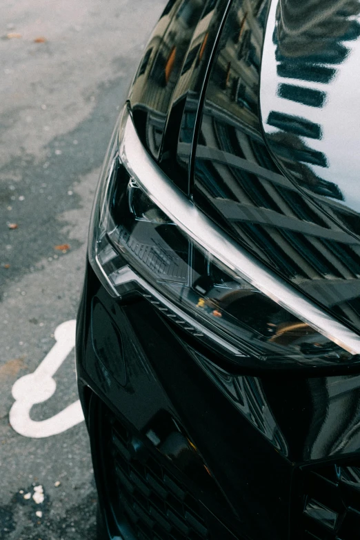 a black car parked on the side of the road, pexels contest winner, photorealism, glossy shiny reflective, abstract detail, accent lighting : : peugot onyx, curved lines