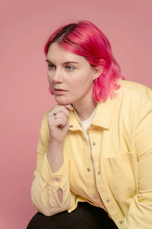 a woman with pink hair posing for a picture, yellow backdrop, pondering, sydney hanson, on clear background