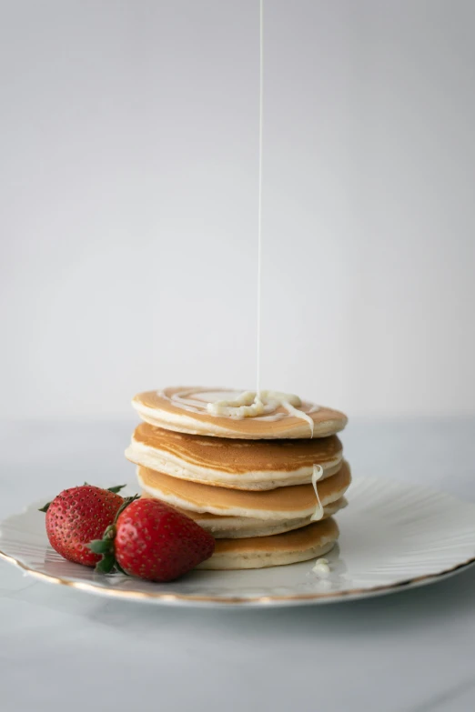 a stack of pancakes sitting on top of a white plate, a portrait, unsplash, kek, strawberry, silver，ivory, pouring