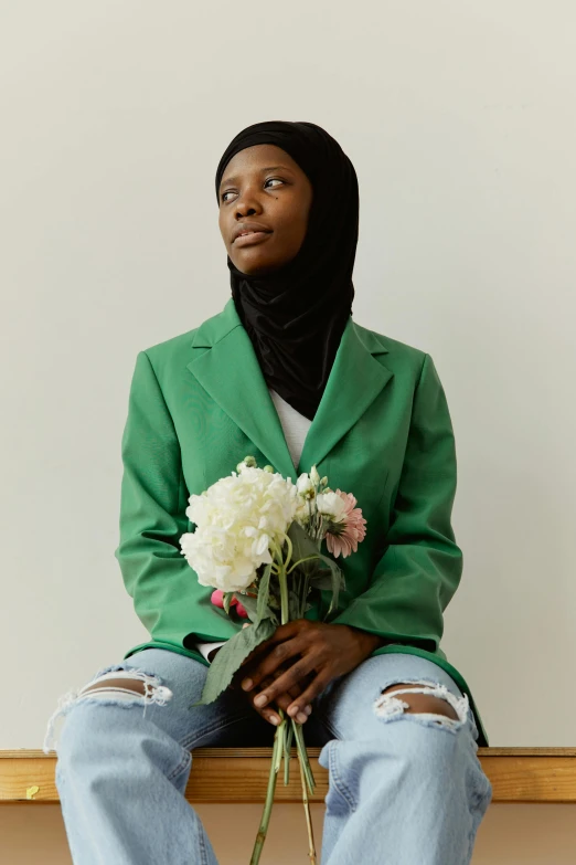 a woman sitting on a bench holding a bunch of flowers, inspired by Maryam Hashemi, hurufiyya, wearing a turtleneck and jacket, jemal shabazz, green skinned, set against a white background