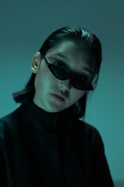 a woman in a black shirt and sunglasses, inspired by Yanjun Cheng, trending on pexels, surrealism, vhs style, asian human, dystopian lighting, handsome girl