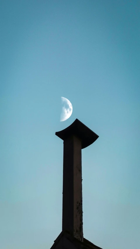 a clock tower with a half moon in the sky, an abstract sculpture, by Attila Meszlenyi, unsplash, chimney, minimalist photo, lunar, unsplash photo contest winner