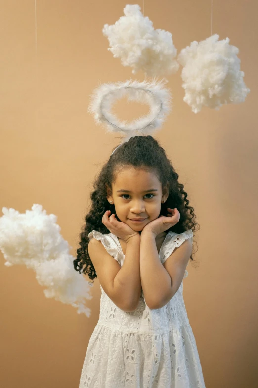 a little girl that is standing in front of some clouds, wearing angel halo, swirly curls, promo photo, high quality upload