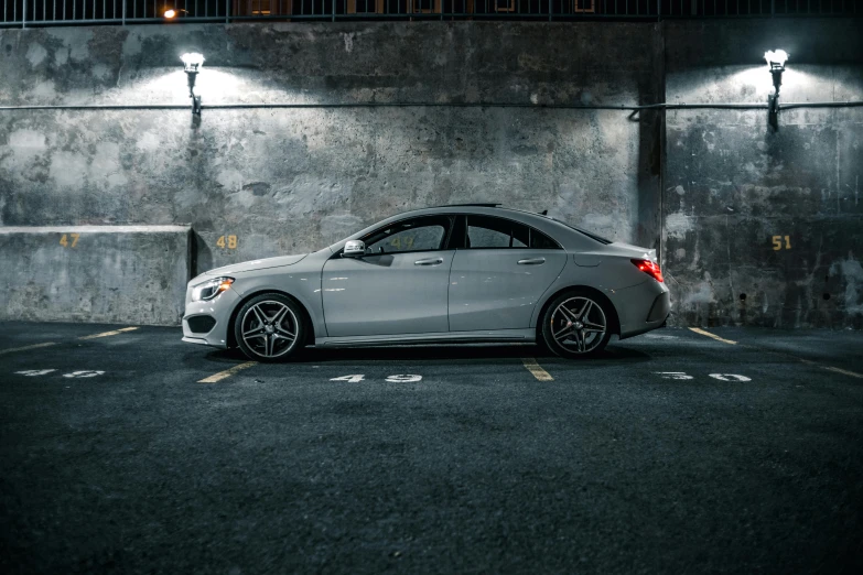 a car parked in a parking lot at night, pexels contest winner, photorealism, mercedez benz, fan favorite, on the concrete ground, profile image