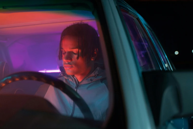 a man sitting in the driver's seat of a car, by Jeffrey Smith, pexels contest winner, 8 0 s neon movie still, riyahd cassiem, frank dillane, profile picture