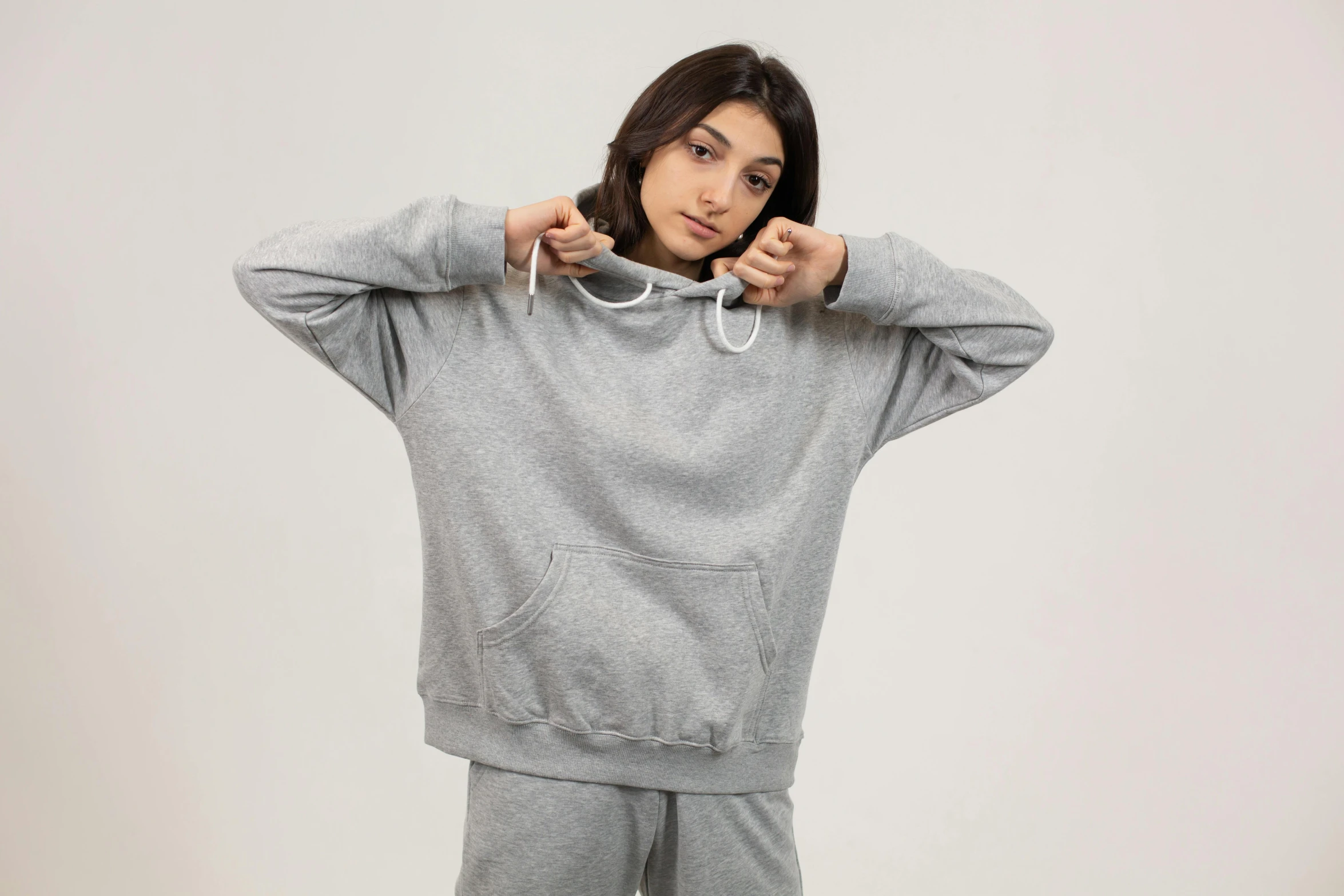 a woman in a grey hoodie poses for a picture, trending on pexels, teddy fresh, front, product shot, federation clothing