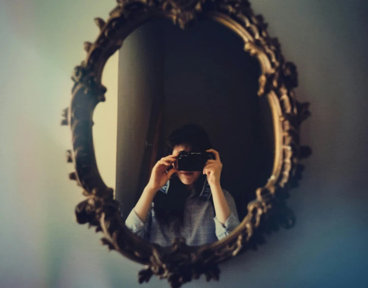 a person taking a picture of themselves in a mirror, a picture, inspired by Elsa Bleda, romanticism, ansel ], head and shoulders in frame, photography ), lomography