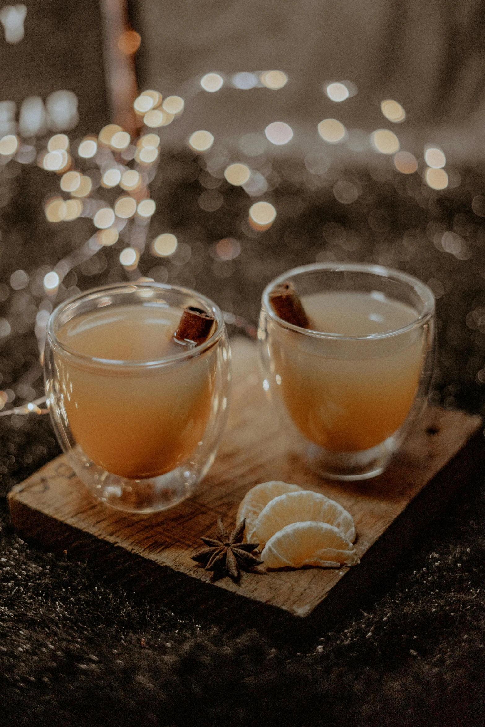 a couple of cups sitting on top of a wooden cutting board, sparkling spirits, cinnamon, thumbnail, grey