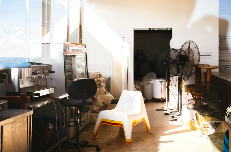 a living room filled with furniture and a fan, a portrait, unsplash, light and space, bakery, secret shady laboratory, aussie baristas, profile image