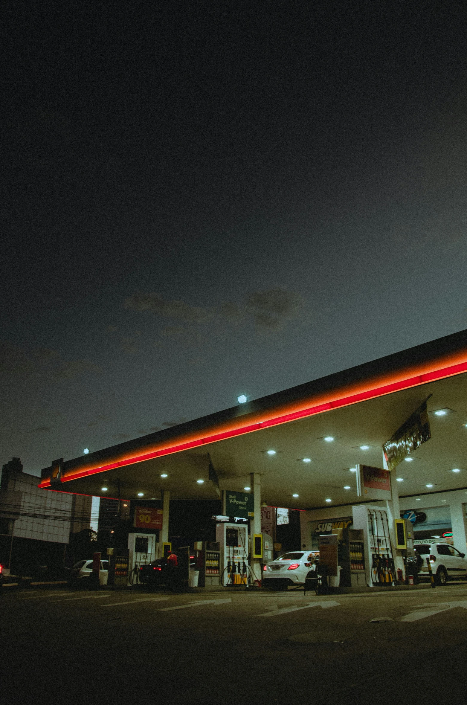 a gas station at night with cars parked in front of it, an album cover, pexels contest winner, petrol energy, 15081959 21121991 01012000 4k, square, wide long view