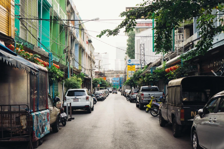 a street filled with lots of traffic next to tall buildings, pexels contest winner, thai, green alleys, square, a colorful