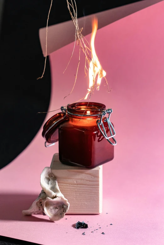 a candle sitting on top of a wooden block, crimson red aura, head in a jar, infused with lightning, detail shot