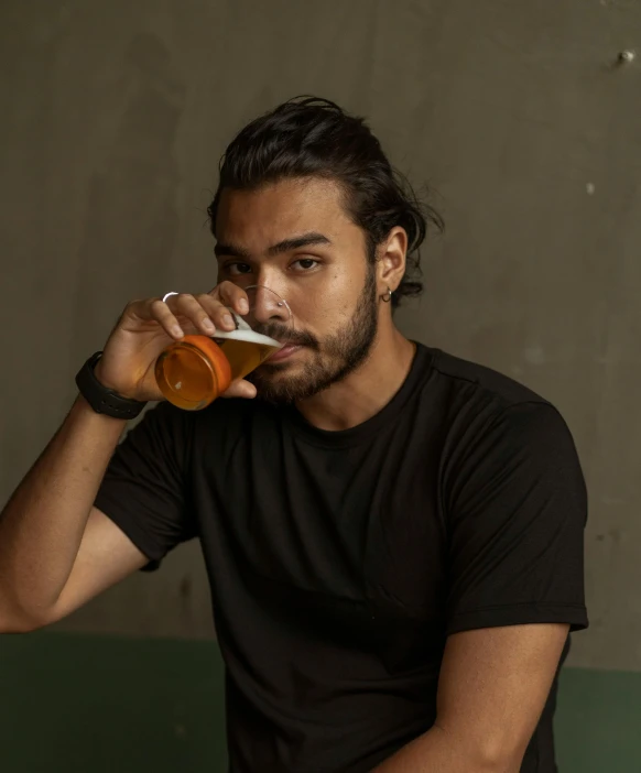 a man sitting on a bench drinking a beer, by Adam Dario Keel, pexels contest winner, photorealism, joe taslim, wearing an orange t shirt, profile image, orelsan