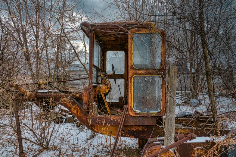 an old tractor sitting in the middle of a snow covered field, a portrait, assemblage, bent rusted iron, portrait image