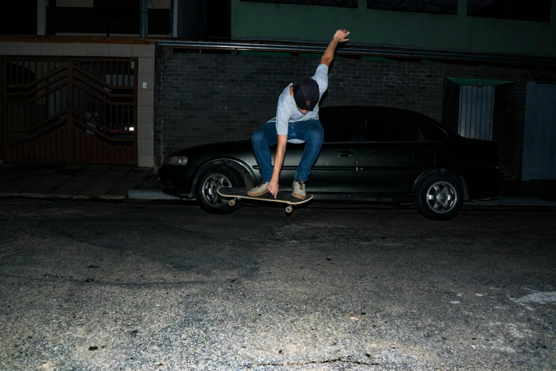 a man flying through the air while riding a skateboard, unsplash, photorealism, street night, car shot, 2 0 0 0's photo, são paulo