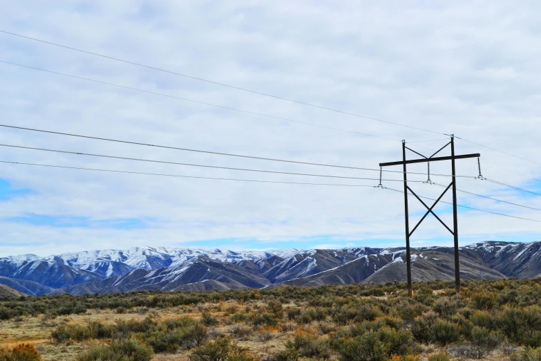 power lines in the desert with mountains in the background, private press, snowy craggy sharp mountains, nature photo