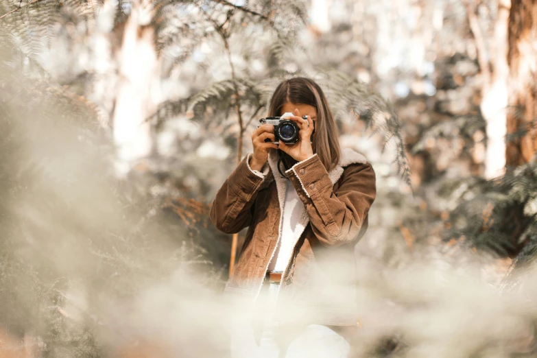 a woman taking a picture with a camera, a picture, inspired by Elsa Bleda, pexels contest winner, amongst foliage, low colour, photos, medium format