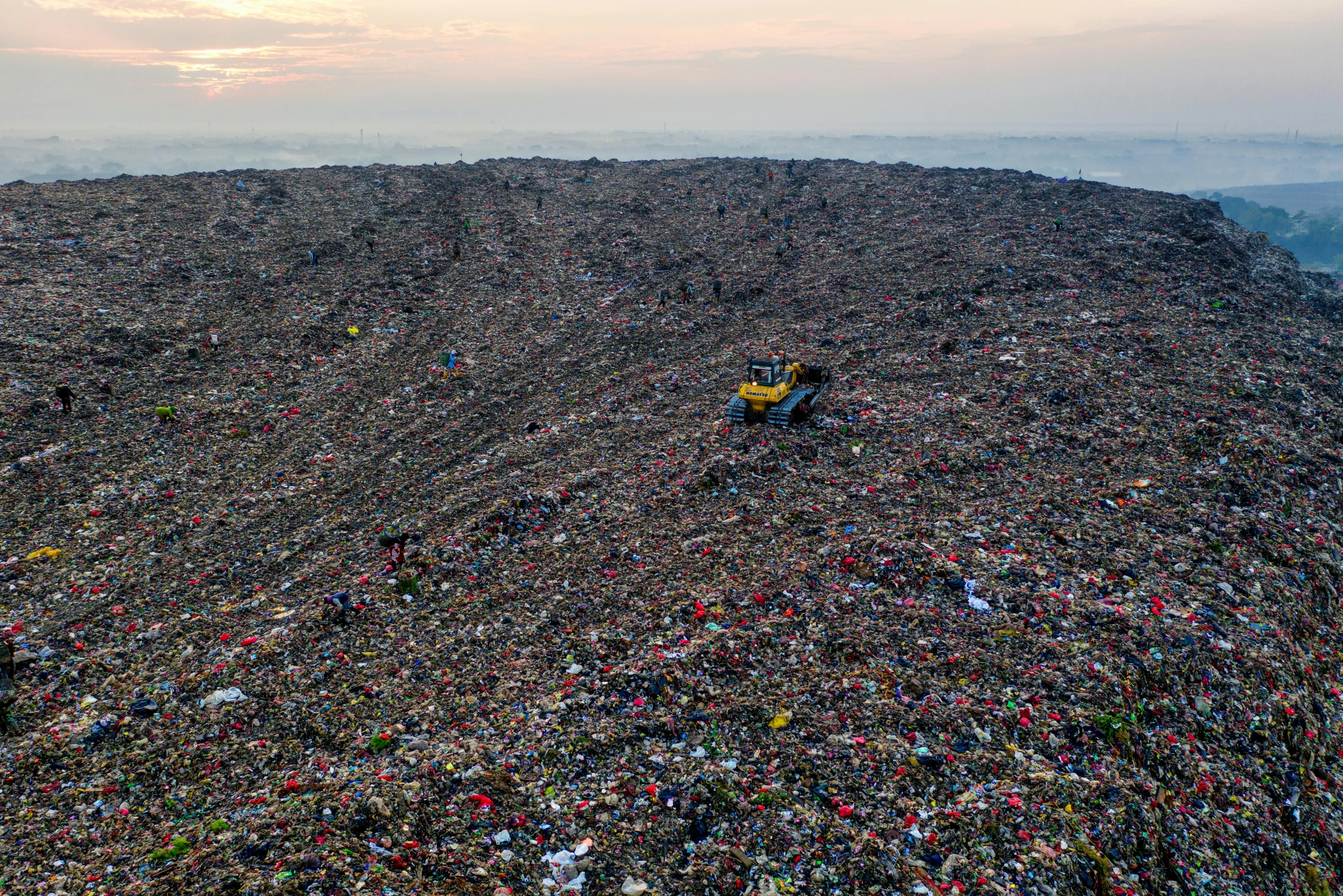 a large pile of garbage sitting on top of a mountain, by Daniel Lieske, reddit, drone photo, 💣 💥, ignant, ultra wide horizon