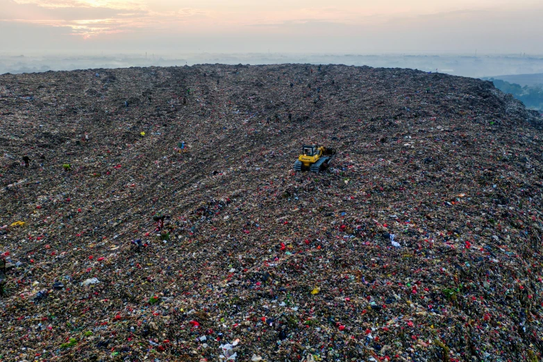 a large pile of garbage sitting on top of a mountain, by Daniel Lieske, reddit, drone photo, 💣 💥, ignant, ultra wide horizon