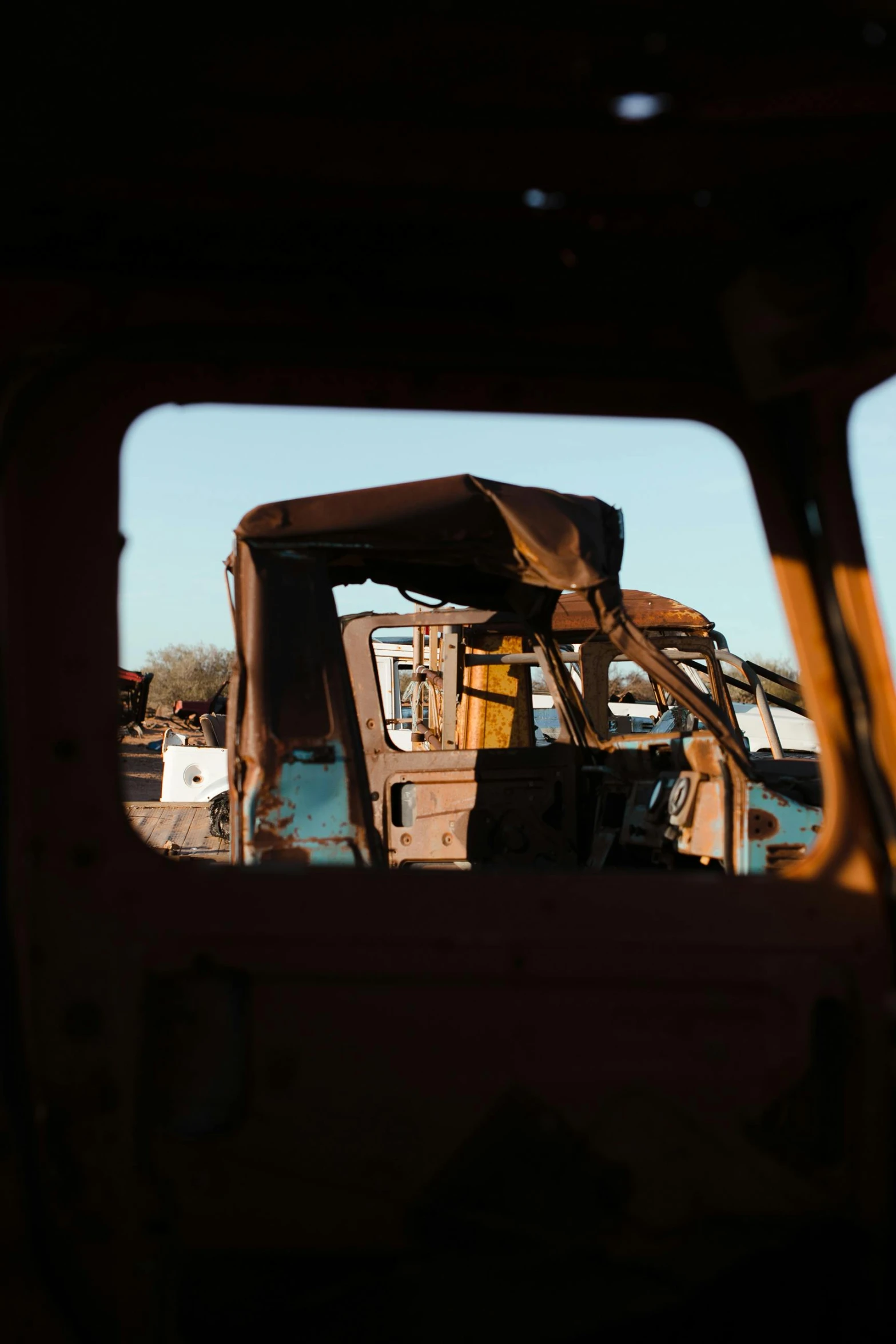 a truck that is sitting in the dirt, unsplash, auto-destructive art, looking through a window frame, shipyard, slide show, in the morning light