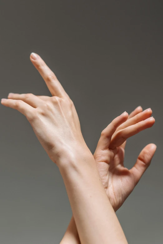 a woman reaching up to catch a frisbee, by Anna Füssli, shutterstock, hyperrealism, hands anatomy, close-up of thin soft hand, on grey background, dancing gracefully