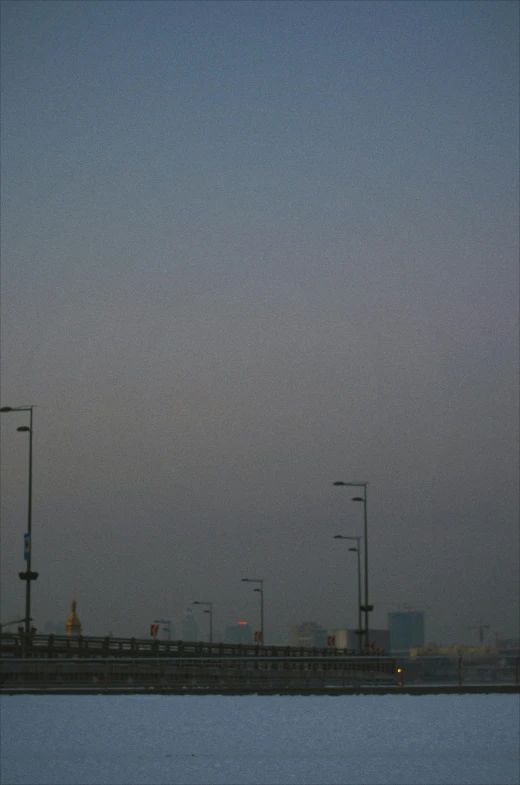 an airplane flying over a body of water, a picture, reddit, postminimalism, jeddah city street, :: morning, streetlamps, smokey atmosphere