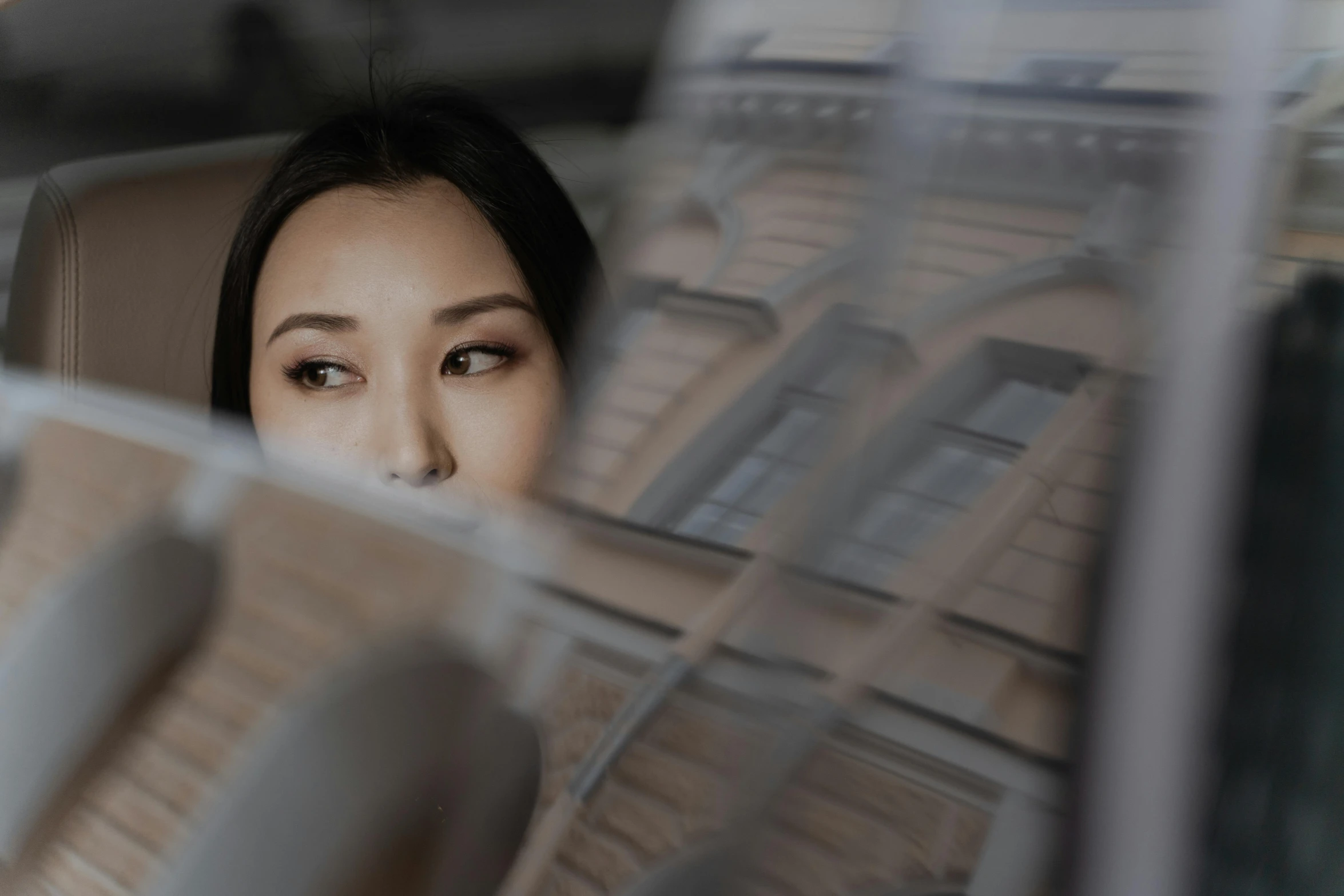 a woman looking out the window of a car, inspired by Yu Zhiding, pexels contest winner, asian beautiful face, in front of a computer, looking down from above, trapped in the backrooms