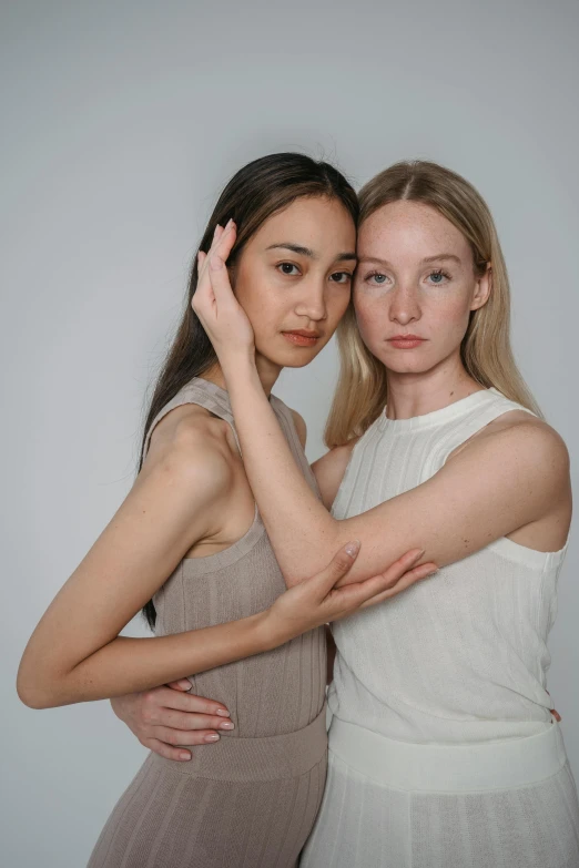 a couple of women standing next to each other, inspired by Wang Duo, trending on pexels, renaissance, synthetic bio skin, wearing a tanktop, with a white complexion, portrait fashion model