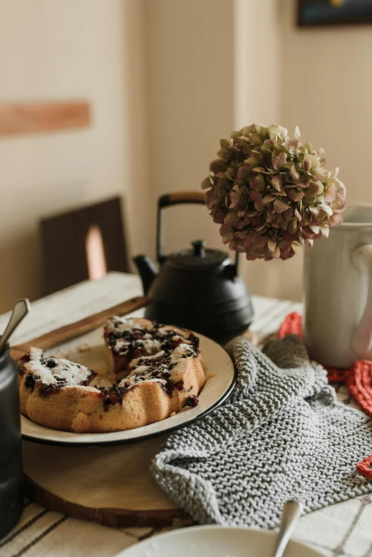 a close up of a plate of food on a table, a still life, unsplash, romanticism, teapot, bakery, indoor shot, with a long